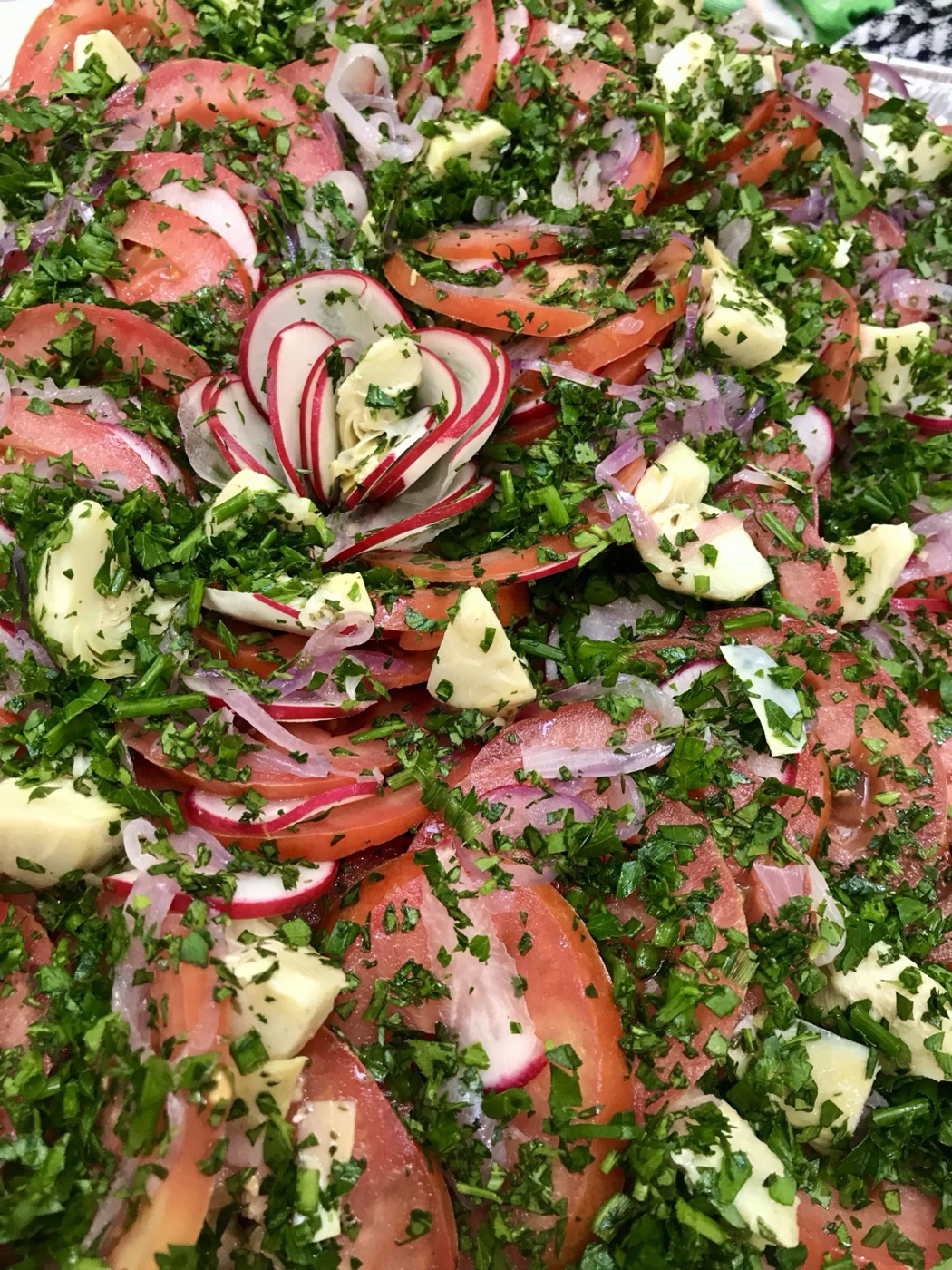 Tomato and bocconcini salad, finished with a radish rose
