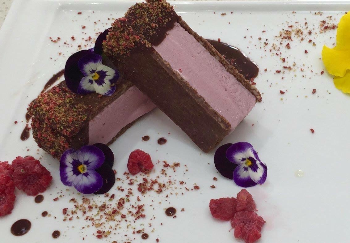 Raspberry chocolate mousse slice with edible pansies