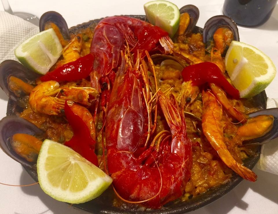 Seafood paella with prawns, mussels and lemon