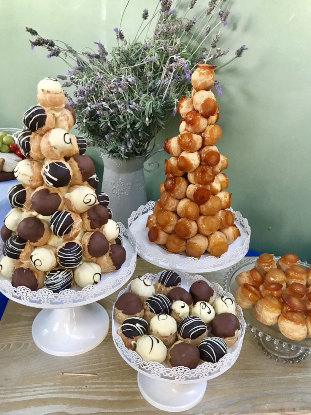 Towers of profiteroles and croquembouche on a dessert table