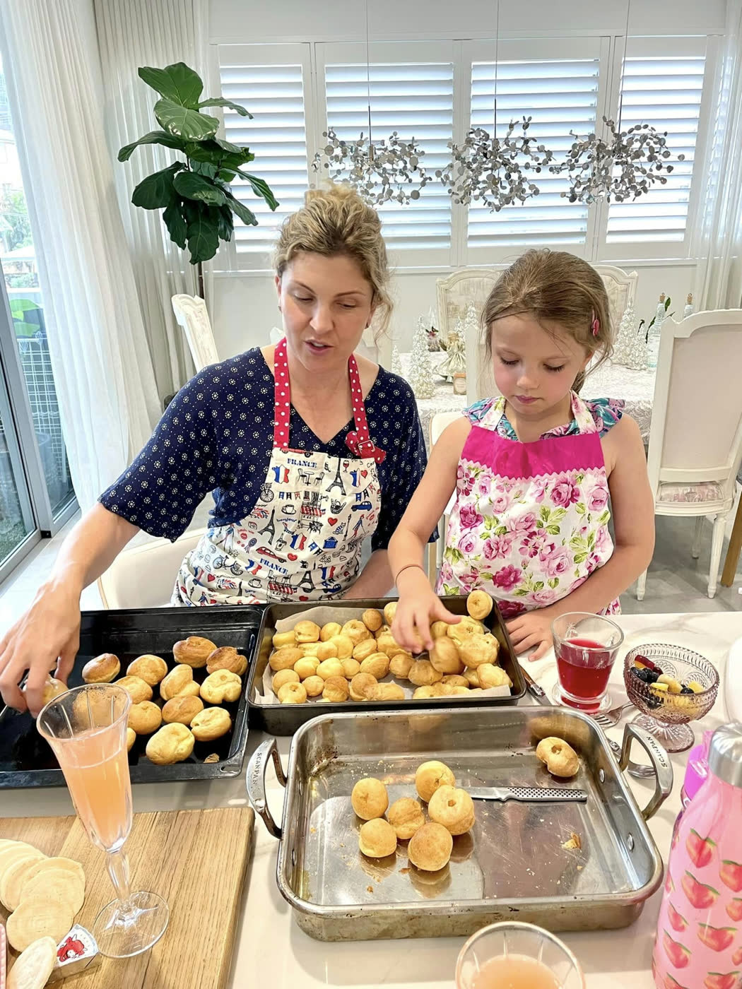 A tray of golden rolls fresh from the oven, being turned out onto the bench