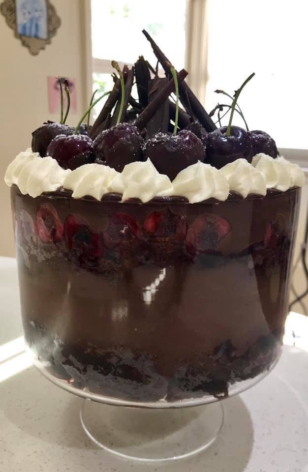 A black forest trifle layered with chocolate, cherries and cream